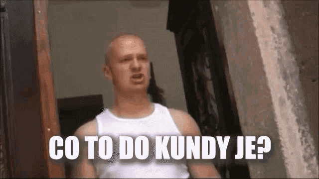 a bald man in a white tank top is standing in front of a door and says `` co to do kundy je ? ''