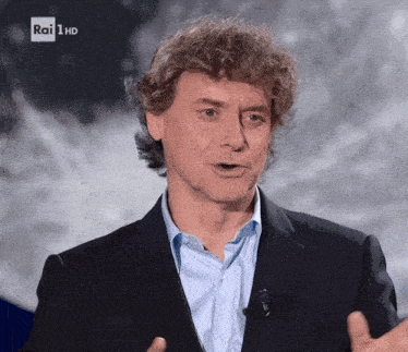a man in a suit and blue shirt is talking on rai 1 hd