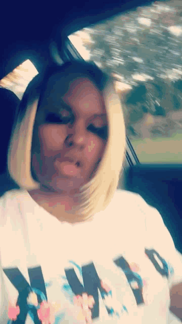 a woman wearing a white shirt that says why