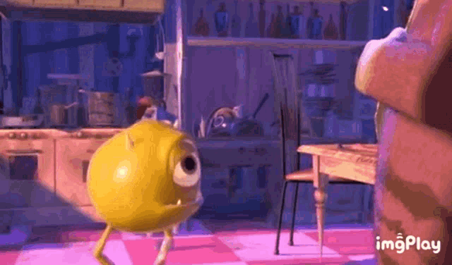 mike wazowski from monsters inc is standing in a kitchen .