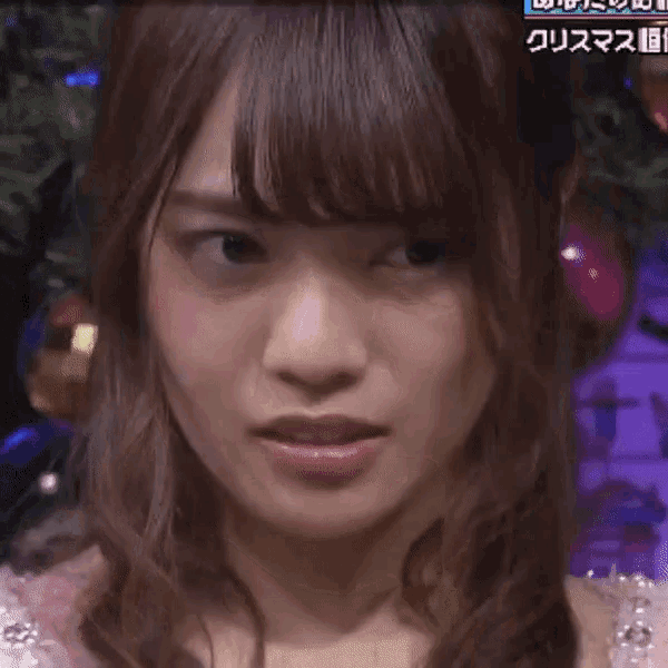 a close up of a woman 's face in front of a christmas tree with chinese writing on it
