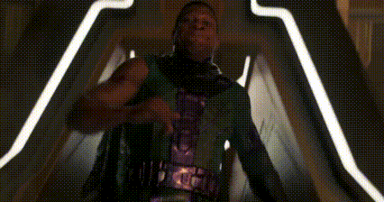 a blurry picture of a person standing in a dark room with lights behind them .