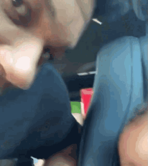 a close up of a person 's face with a blue shirt on