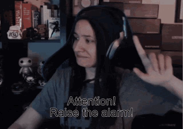 a woman wearing headphones says " attention ! raise the alarm ! "