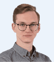 a young man wearing glasses and a grey shirt is standing in front of a white background .