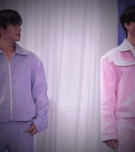 a man in a purple jacket is standing next to a man in a pink jacket