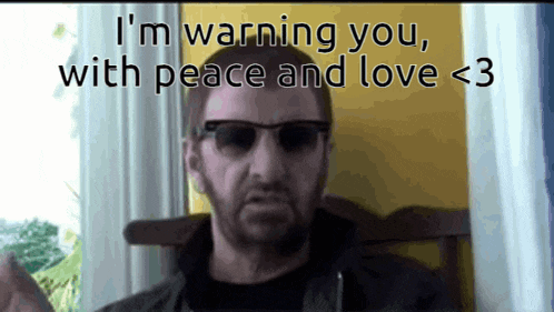 a man wearing sunglasses is warning someone with peace and love < 3