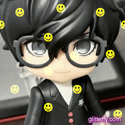 a close up of a doll with glasses and smiley faces on it