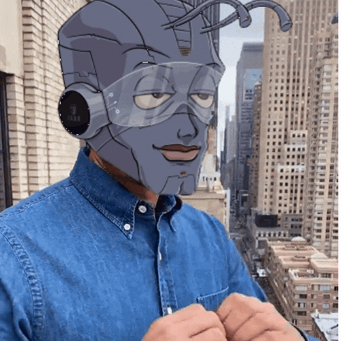 a man in a denim shirt has a robot head on his head