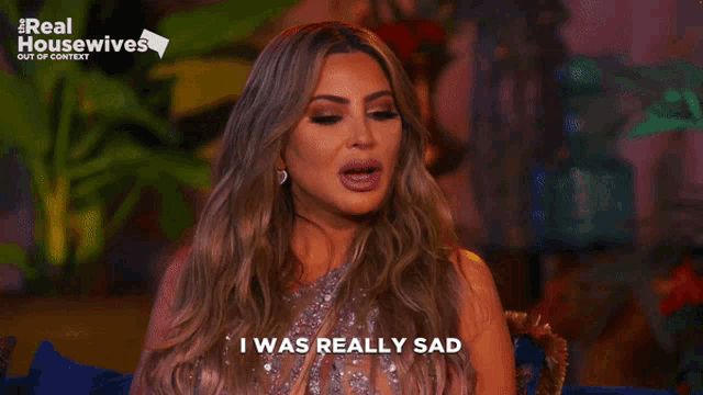 a woman says i was really sad in front of a real housewives sign