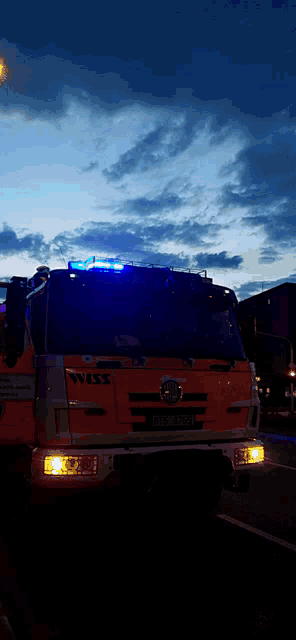 a nissan fire truck with blue lights on the front