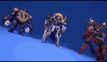 three robots standing next to each other on a blue surface