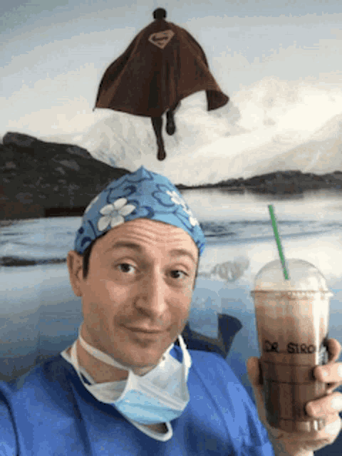 a doctor is holding a cup of coffee with dr. giro written on the cup