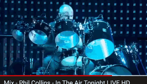 a man playing drums in front of a screen that says " mix phil collins - in the air tonight live hd "