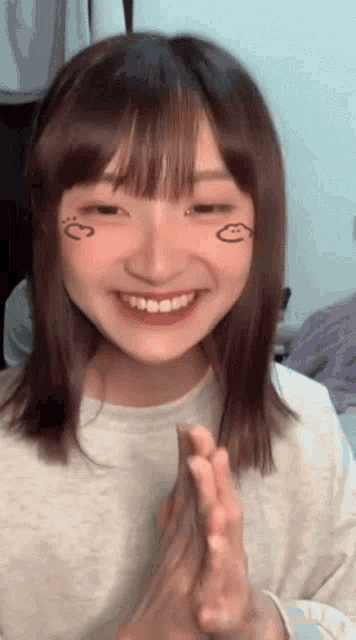 a girl with a smiley face on her face