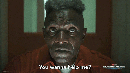 a man in a prison uniform says " you wanna help me " in front of a captain america poster