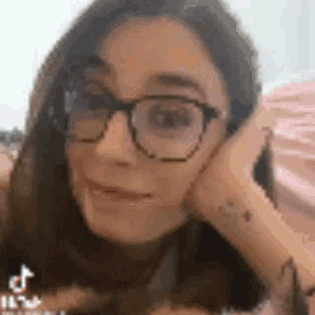 a close up of a woman wearing glasses .