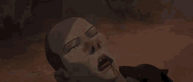 a person with a bandage on their arm is laying on the ground