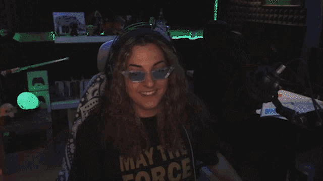 a woman wearing a shirt that says force with a microphone in the background