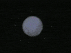 a person in a green suit is laying on a white ball