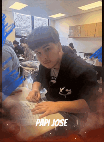 a young man sits at a desk with the name papi jose written on the bottom