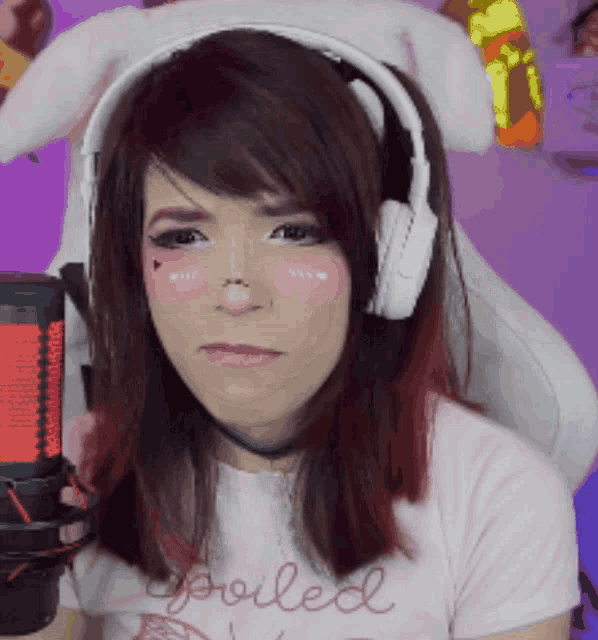 a woman wearing headphones and a t-shirt that says spoiled