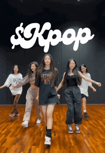a group of young girls are dancing in front of a kpop logo