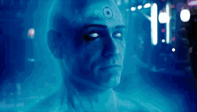 a close up of a man 's face with a blue background and a clock on his forehead .
