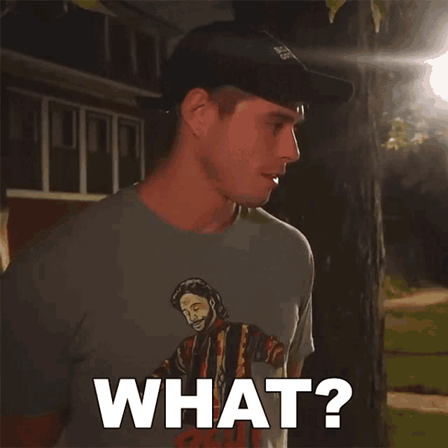 a man wearing a hat and a t-shirt that says what on it