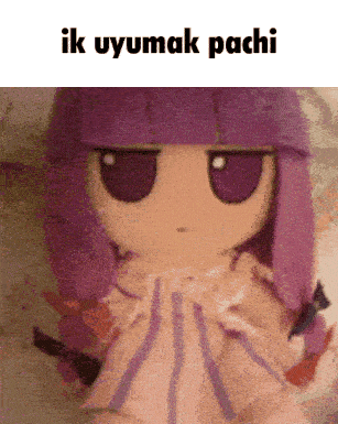a stuffed doll with purple hair and the words " ik uyumak pachi " above it