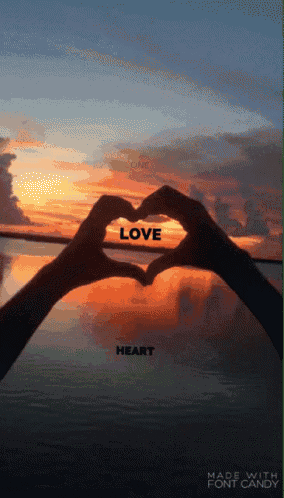 a person making a heart shape with their hands with the words love heart below them