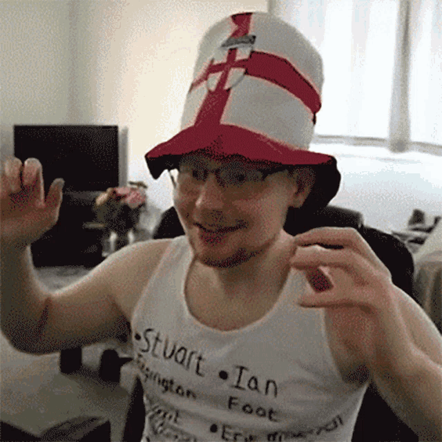 a man wearing a hat and a shirt that says stuart