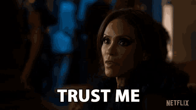 a woman is sitting on a couch and says `` trust me '' .