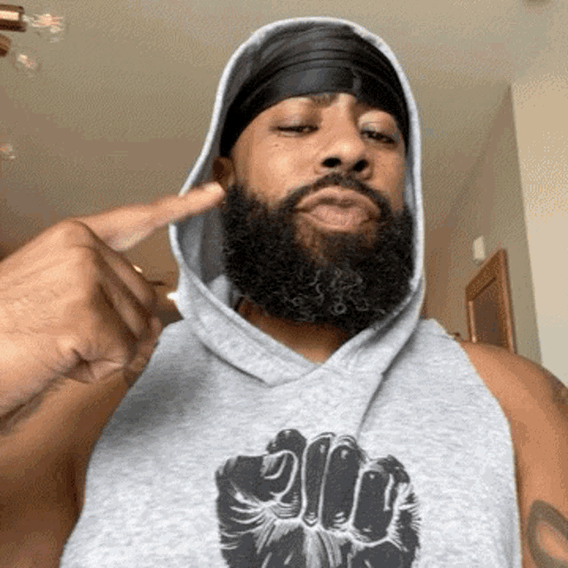 a man with a beard wearing a hoodie and a headband