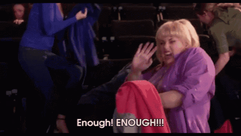 a woman in a purple shirt is holding a red jacket and screaming enough enough !!!