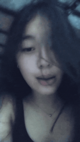 a blurry picture of a woman 's face with her mouth open