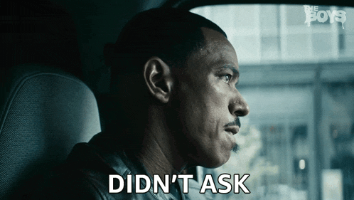 a man in a car says " didn 't ask " in front of a sign that says the boys
