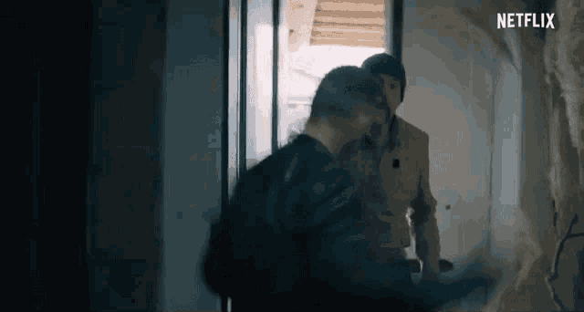 a couple of men are standing next to each other in a doorway .