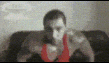 a blurry image of a man in a red tank top
