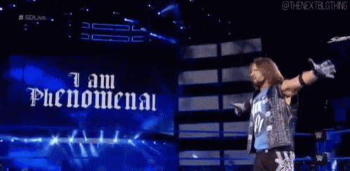 a wrestler stands in front of a sign that says i am phenomenal