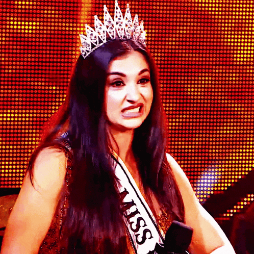 a woman wearing a tiara and a miss sash