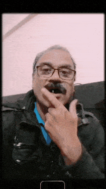 a man wearing glasses and a fake mustache holds his finger to his mouth