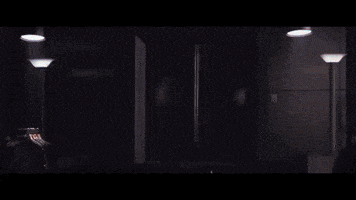 a lightning bolt is coming out of a doorway in a dark room