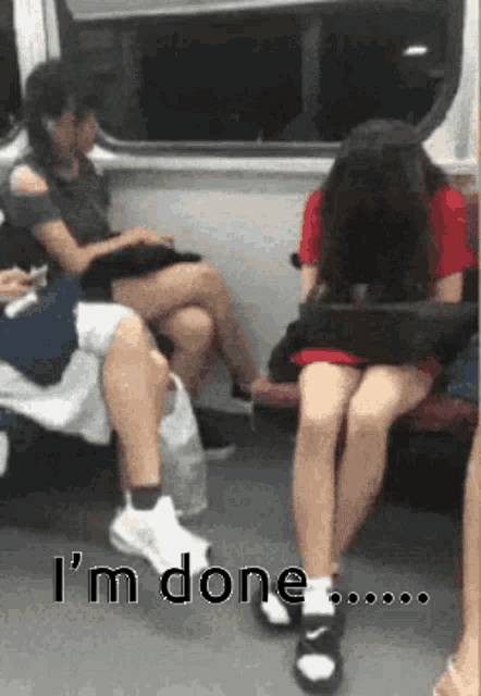 a woman sits on a train with her legs crossed and the words i 'm done