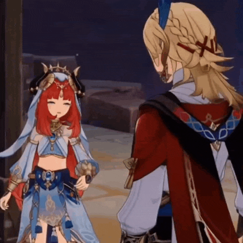 a man and a woman are standing next to each other in a game .