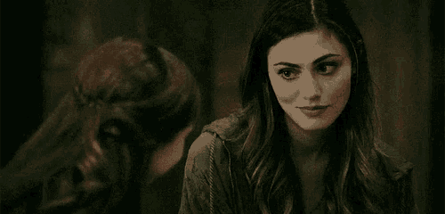 a woman is smiling while looking at another woman .