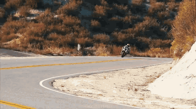 a person is riding a motorcycle on a road