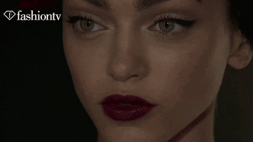 a close up of a woman 's face with fashiontv written on the bottom