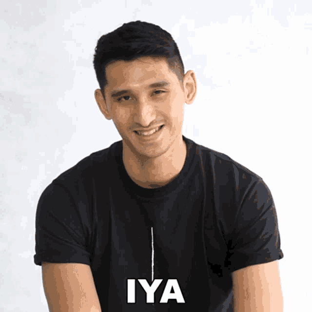 a man wearing a black shirt with the word iya written on it