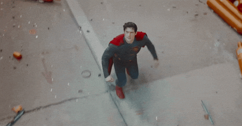 a man in a superman costume says " good gosh there 's gotta be a better way to do this .. "